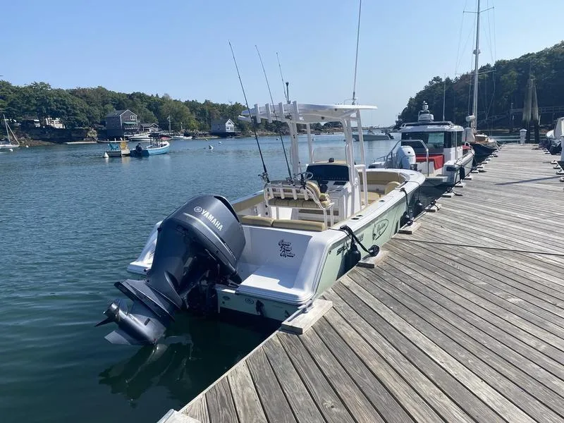 Slide: The Image of 2022 Sportsman 231 Heritage boat docked at a scenic marina. - 11