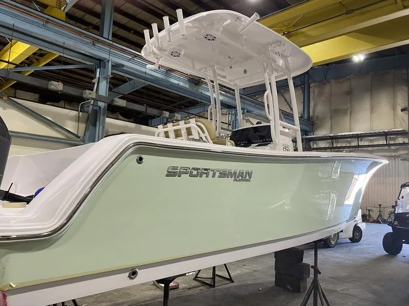 Slide: The Image of 2022 Sportsman 231 Heritage boat in a warehouse, side view. - 12