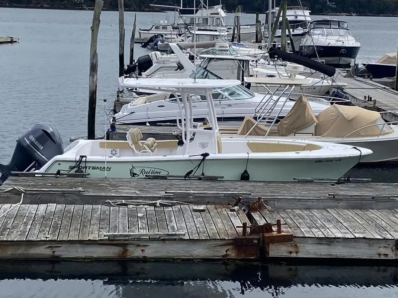 Slide: The Image of 2022 Sportsman 231 Heritage boat docked at marina with other vessels. - 3