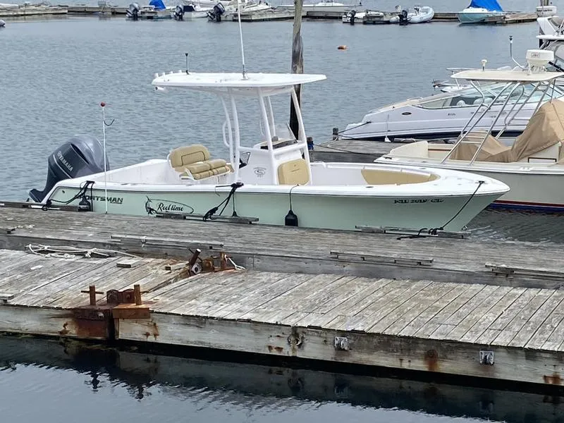 Slide: The Image of 2022 Sportsman 231 Heritage boat docked at marina with other vessels. - 4