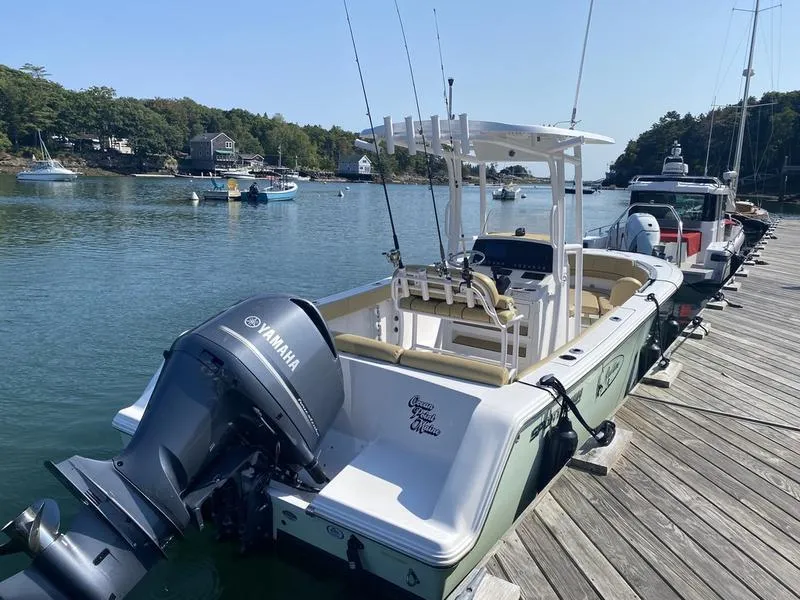 Slide: The Image of 2022 Sportsman 231 Heritage boat docked on a scenic waterfront. - 7