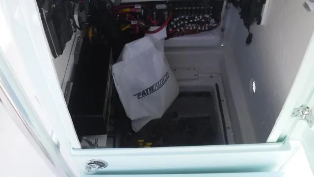 Slide: The Image of Interior view of a 2025 Pathfinder 2500 Hybrid boat compartment with wiring and storage. - 18