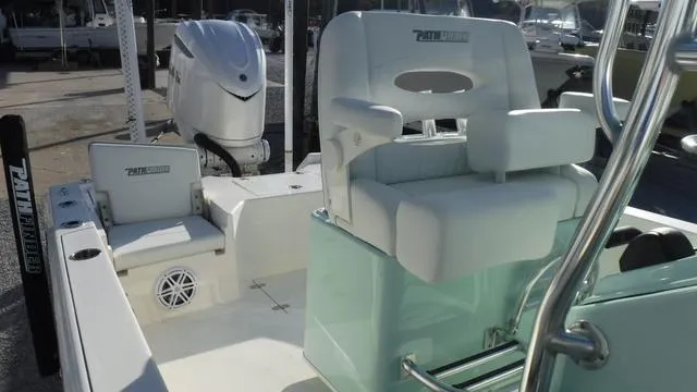 Slide: The Image of 2025 Pathfinder 2500 Hybrid boat interior with seating and motor. - 22