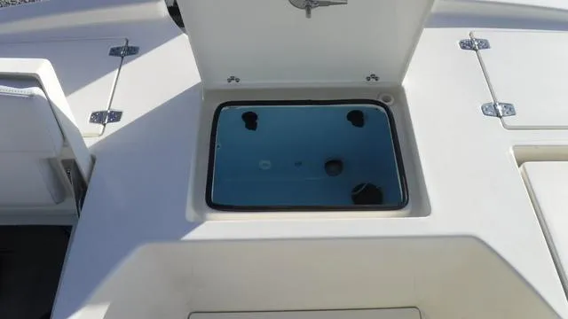 Slide: The Image of 2025 Pathfinder 2500 Hybrid boat storage compartment with open hatch. - 27