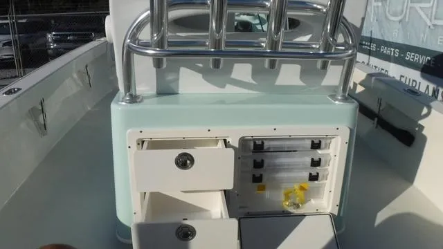 Slide: The Image of Pathfinder 2500 Hybrid 2025 boat console with storage compartments and rod holders. - 29