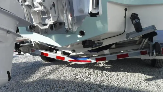 Slide: The Image of 2025 Pathfinder 2500 Hybrid boat on a trailer, rear view, gravel background. - 6