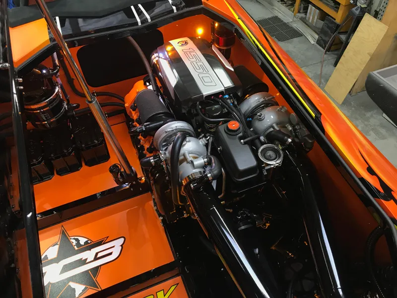 Slide: The Image of Engine compartment of a 2018 Daves Custom Boats M-44, showcasing powerful engine components. - 16