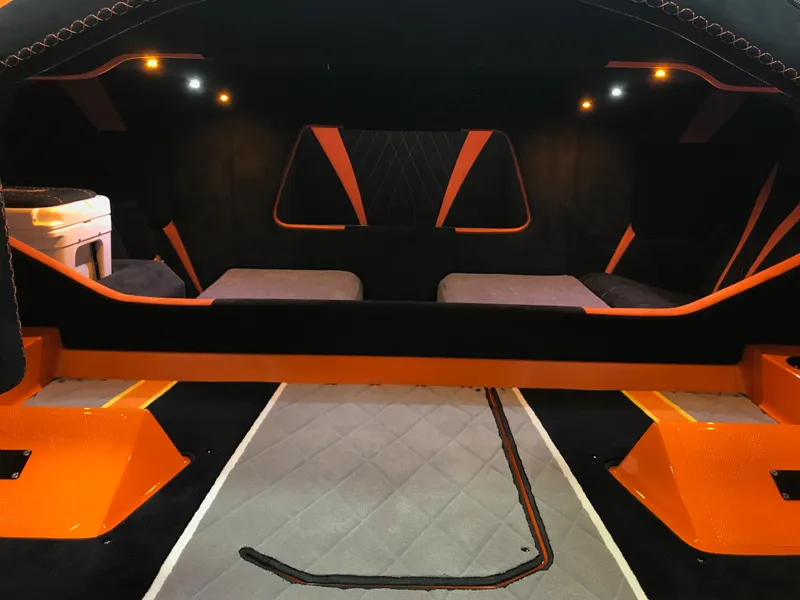 Slide: The Image of Interior of 2018 Daves Custom Boats M-44, featuring modern design with orange accents. - 17