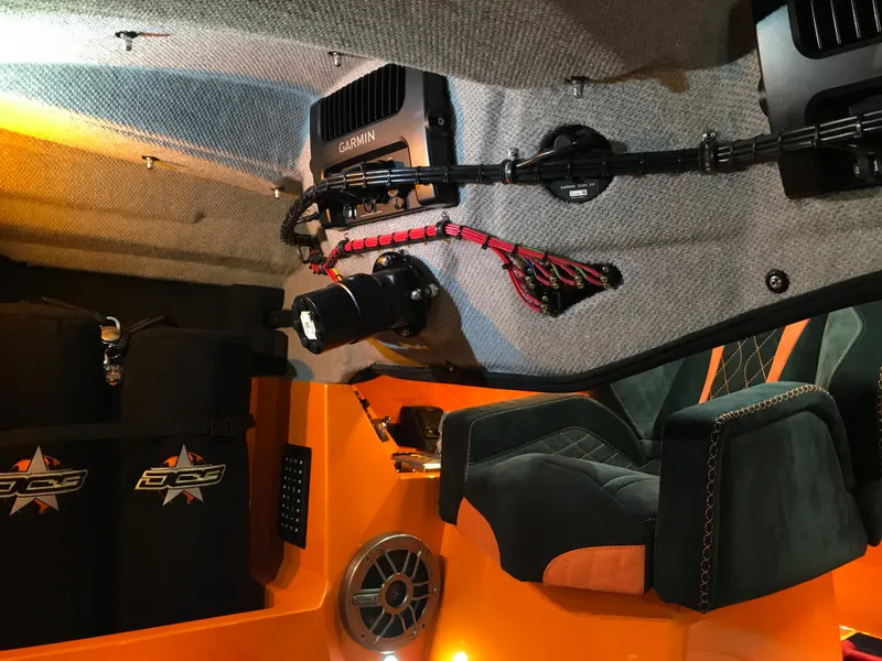 Slide: The Image of Interior of 2018 Daves Custom Boats M-44 with orange accents and advanced controls. - 20