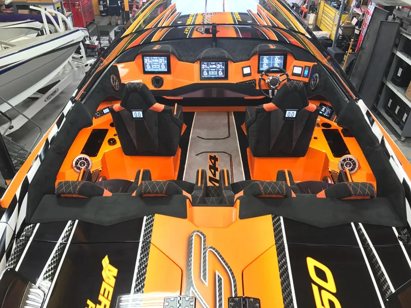 Slide: The Image of 2018 Daves Custom Boats M-44 interior with vibrant orange and black design, advanced dashboard. - 6