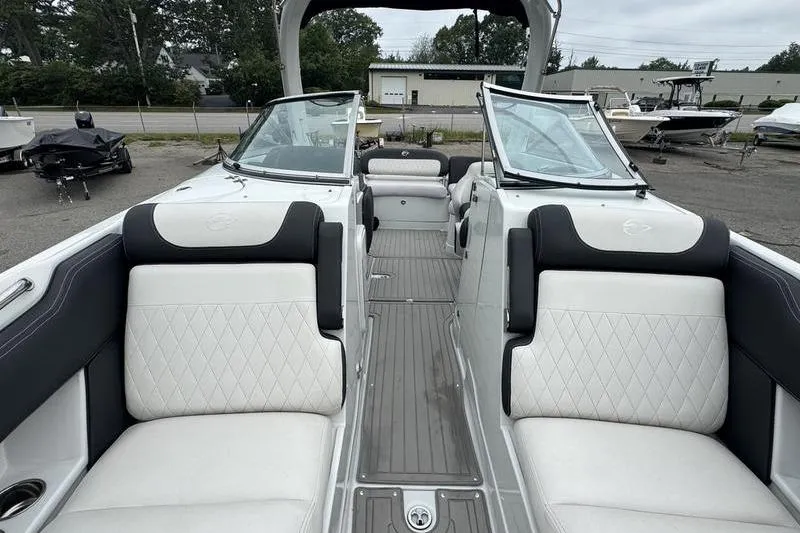 Slide: The Image of 2020 Crownline Eclipse E255 boat interior with white seating and open windshield. - 11