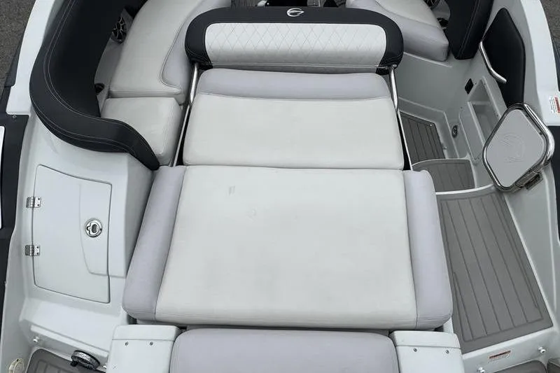 Slide: The Image of 2020 Crownline Eclipse E255 boat interior with cushioned seating and sleek design. - 13
