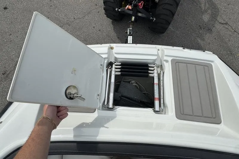 Slide: The Image of 2020 Crownline Eclipse E255 boat with open storage compartment and ladder. - 3