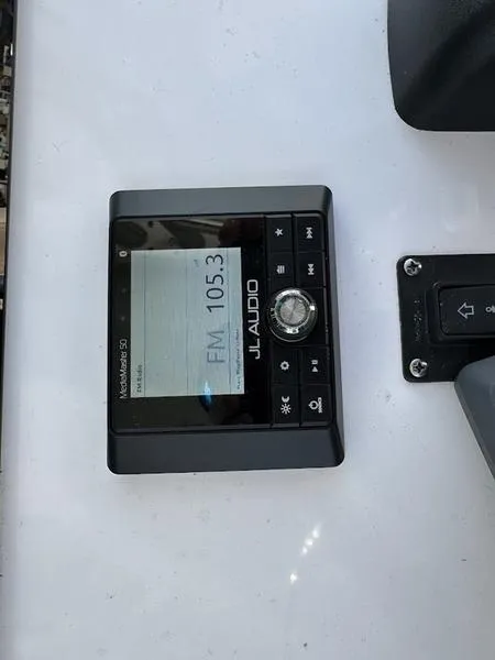 Slide: The Image of JL Audio marine stereo display on 2020 Sportsman 241 Heritage boat. - 14