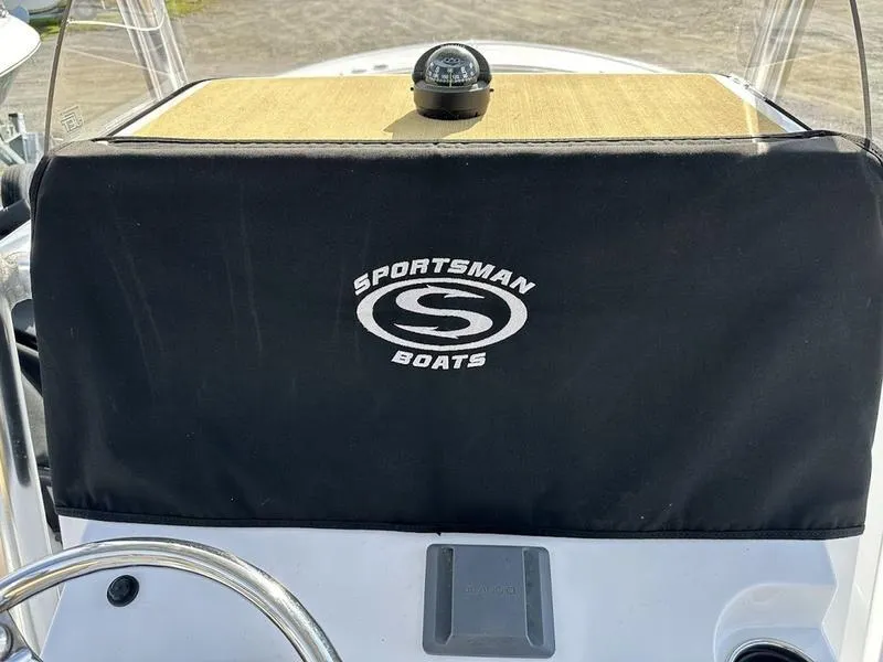 Slide: The Image of 2020 Sportsman 241 Heritage boat dashboard with compass and protective cover. - 15