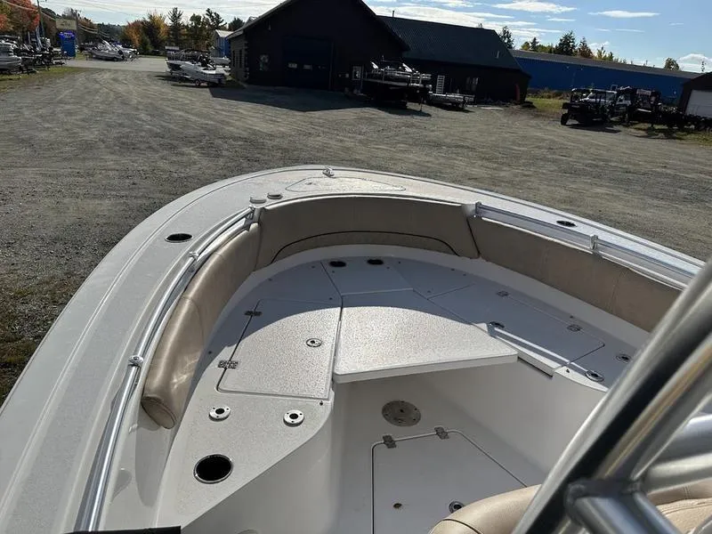 Slide: The Image of 2020 Sportsman 241 Heritage boat, spacious deck, parked outdoors under clear sky. - 17