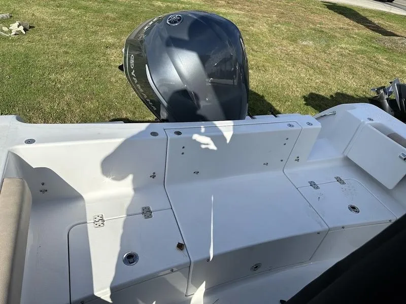 Slide: The Image of 2020 Sportsman 241 Heritage boat with Yamaha outboard motor, parked on grass. - 18