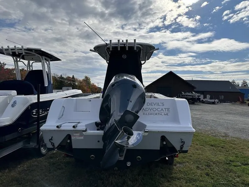 Slide: The Image of 2020 Sportsman 241 Heritage boat with outboard motor, parked outdoors under cloudy sky. - 5