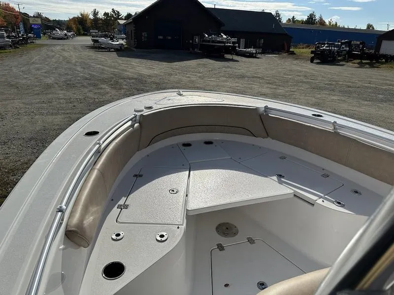 Slide: The Image of 2020 Sportsman 241 Heritage boat interior with seating and storage, parked outdoors. - 6