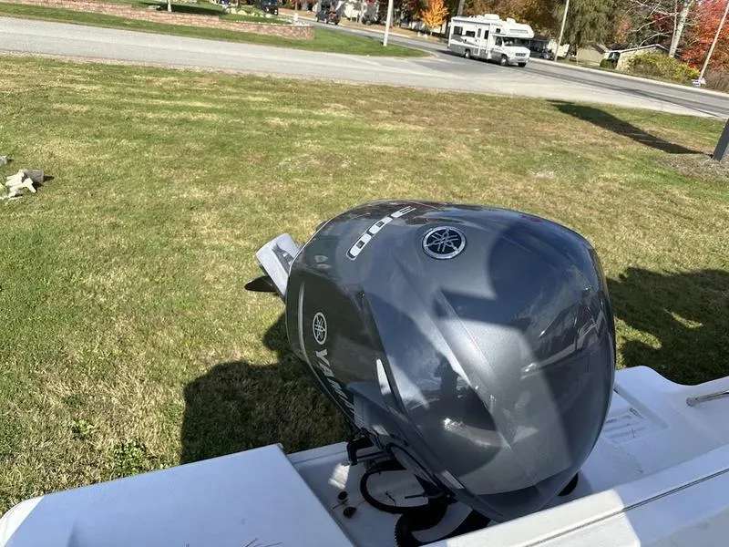 Slide: The Image of Yamaha outboard motor on a 2020 Sportsman 241 Heritage boat, parked on grass. - 7