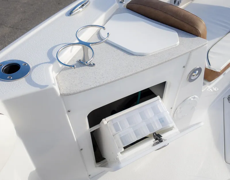 Slide: The Image of Stingray 216CC 2025 boat interior with storage compartment and cup holders. - 10