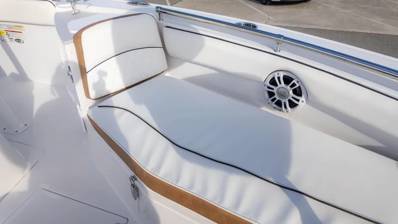 Slide: The Image of 2025 Stingray 216CC boat interior with white cushioned seating and speaker. - 11