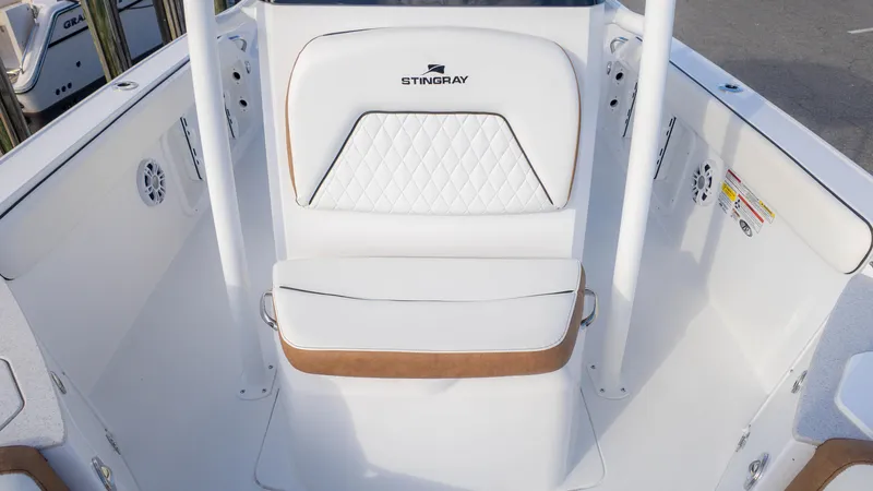 Slide: The Image of 2025 Stingray 216CC boat interior with white cushioned seating and sleek design. - 15
