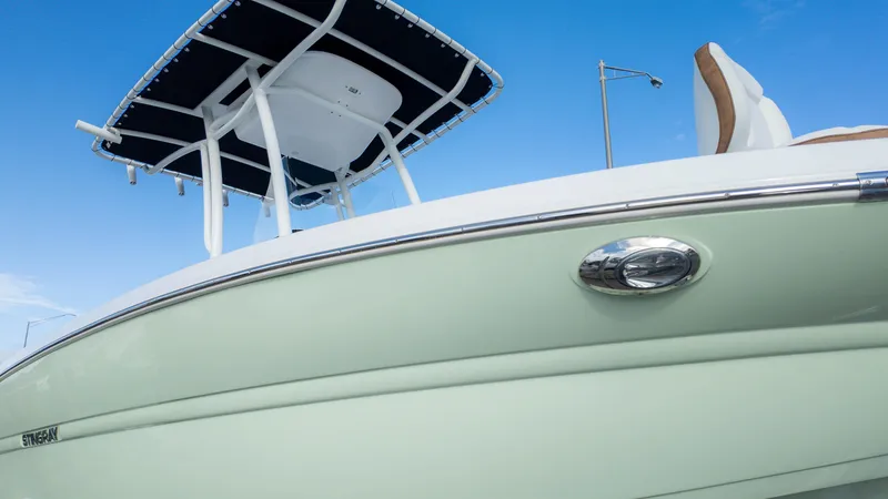 Slide: The Image of 2025 Stingray 216CC boat with sleek design and modern features against a clear blue sky. - 20