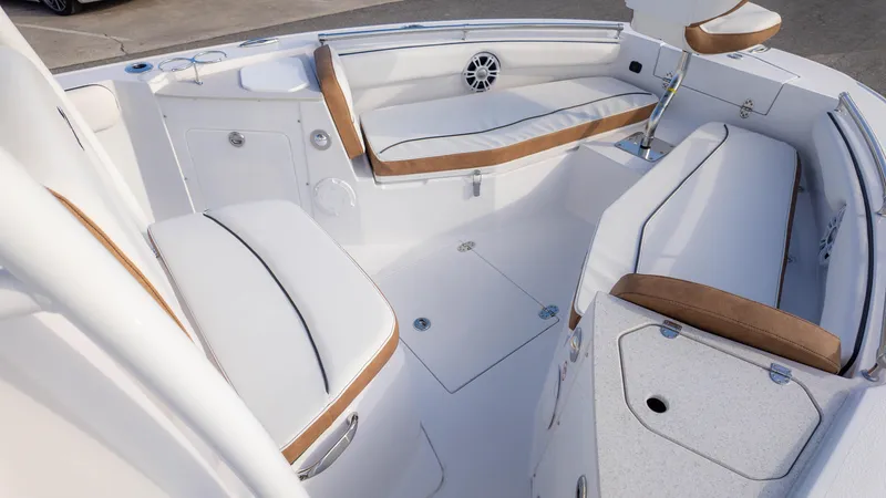 Slide: The Image of 2025 Stingray 216CC boat interior with white and tan seating, modern design. - 23