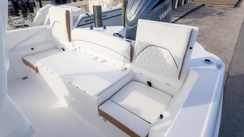 Slide: The Image of 2025 Stingray 216CC boat interior with white cushioned seating and Yamaha engine. - 25