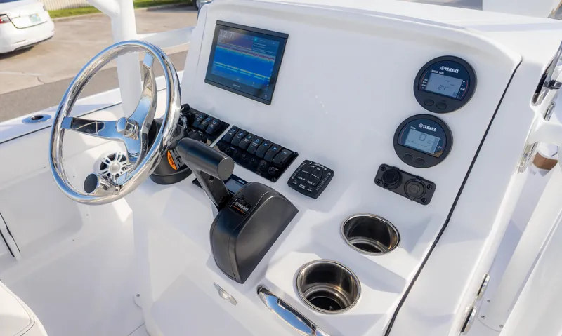 Slide: The Image of 2025 Stingray 216CC boat dashboard with steering wheel, controls, and digital displays. - 28