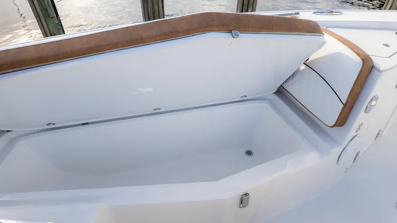 Slide: The Image of 2025 Stingray 216CC boat storage compartment with cushioned seating. - 29