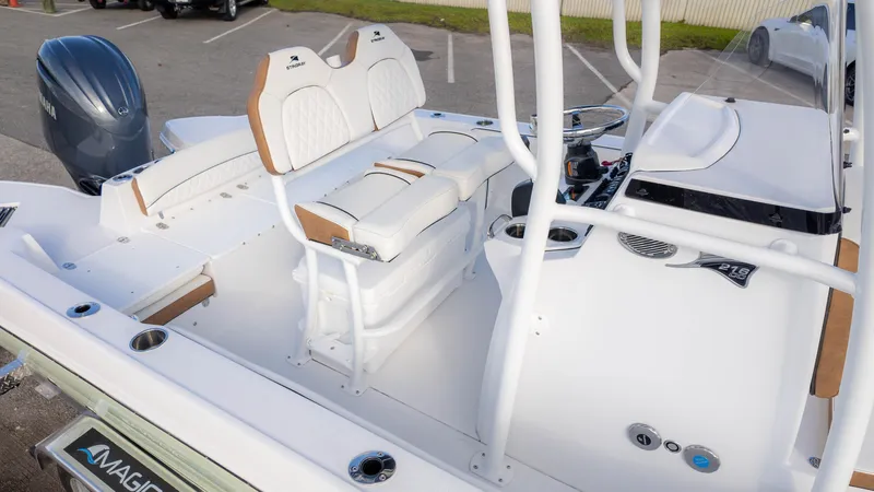 Slide: The Image of 2025 Stingray 216CC boat interior with white seating and Yamaha engine. - 3