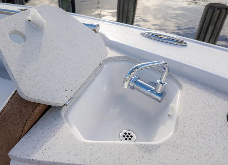 Slide: The Image of 2025 Stingray 216CC boat sink with chrome faucet and cover. - 31