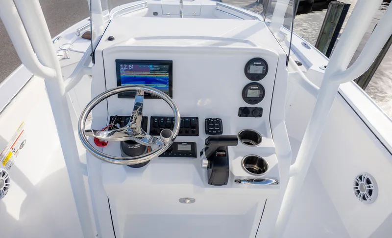 Slide: The Image of 2025 Stingray 216CC boat dashboard with steering wheel and electronic controls. - 7