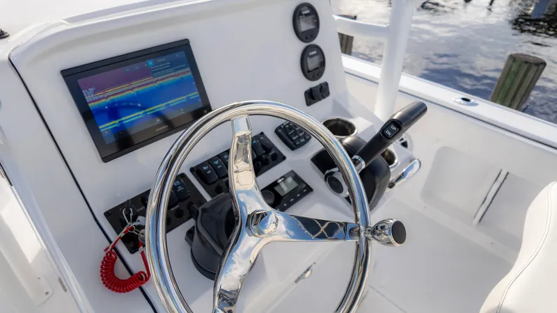 Slide: The Image of 2025 Stingray 216CC boat dashboard with steering wheel and navigation display. - 8