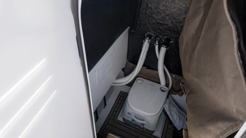 Slide: The Image of 2025 Stingray 216CC boat interior with plumbing and storage area. - 9