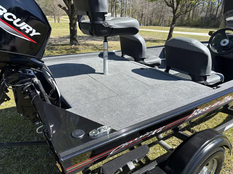 Slide: The Image of 2025 Tracker Bass Tracker Classic XL boat with Mercury engine, featuring spacious seating and carpeted deck. - 12