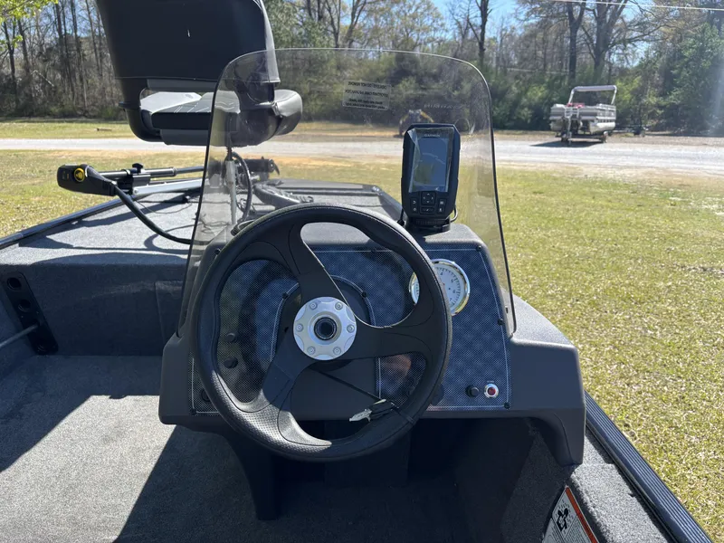 Slide: The Image of 2025 Tracker Bass Tracker Classic XL boat dashboard with steering wheel and navigation system. - 13