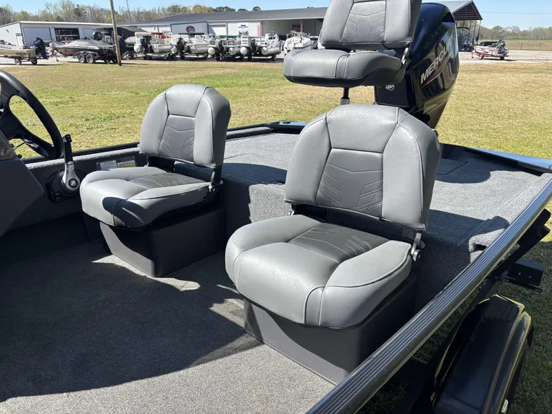 Slide: The Image of 2025 Tracker Bass Tracker Classic XL boat interior with gray seating and steering wheel. - 14