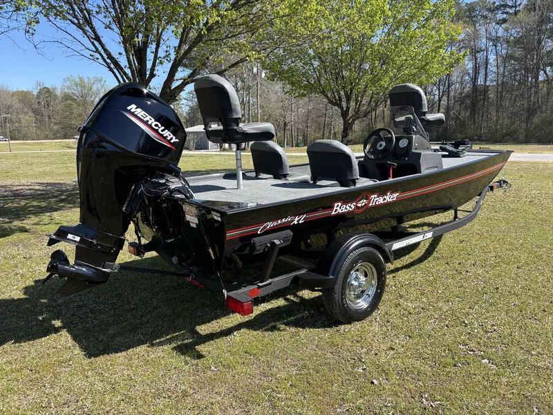 Slide: The Image of 2025 Tracker Bass Tracker Classic XL boat on grass with Mercury engine. - 9