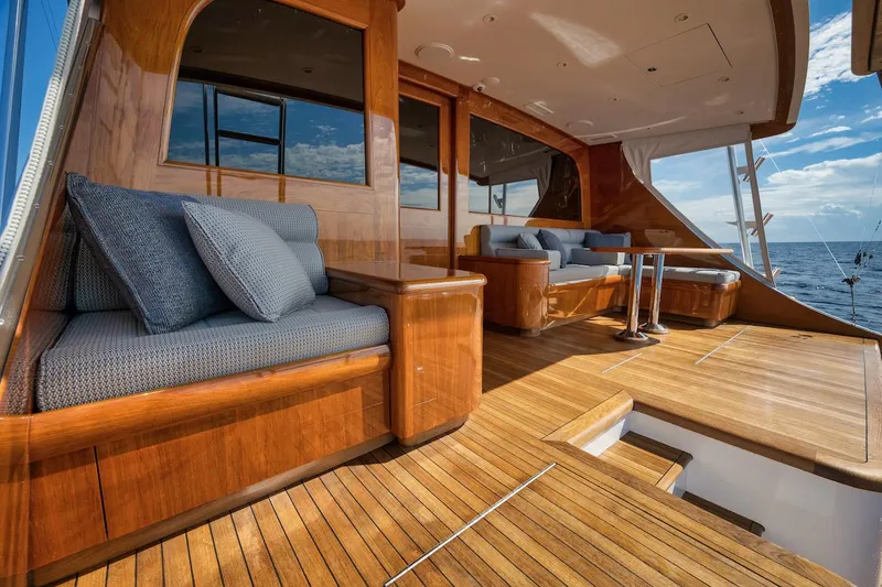 Slide: The Image of Luxurious 2016 Merritt 86' Enclosed Flybridge yacht with elegant wooden deck and seating. - 15
