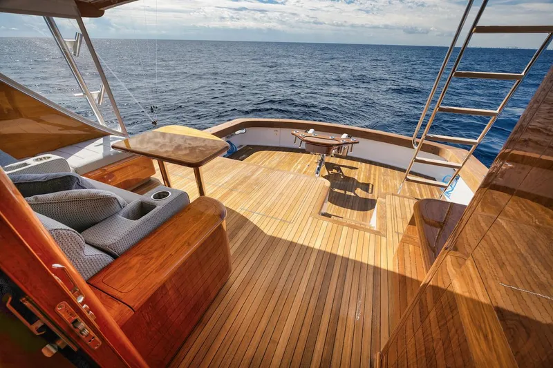 Slide: The Image of Luxurious 2016 Merritt 86' yacht deck with ocean view and wooden flooring. - 16
