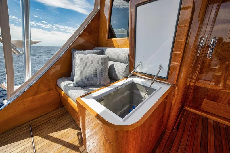 Slide: The Image of Luxurious 2016 Merritt 86' yacht interior with cushioned seating and open storage compartment. - 18