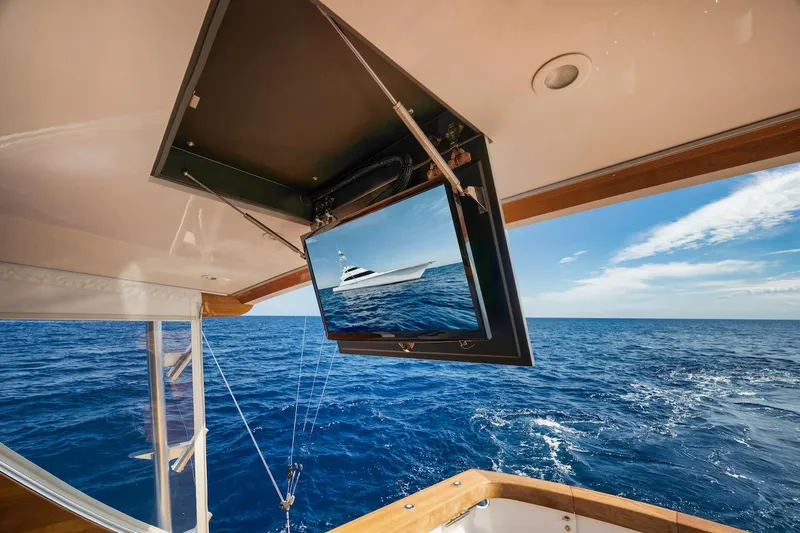 Slide: The Image of 2016 Merritt 86' Enclosed Flybridge yacht with ocean view and ceiling-mounted TV. - 20