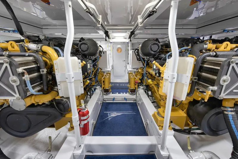 Slide: The Image of Engine room of 2016 Merritt 86' Enclosed Flybridge yacht, showcasing dual engines and equipment. - 27