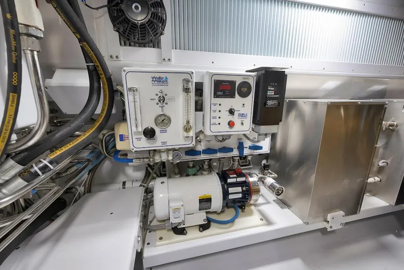 Slide: The Image of Engine room of 2016 Merritt 86' Enclosed Flybridge, showcasing mechanical equipment and control panels. - 30