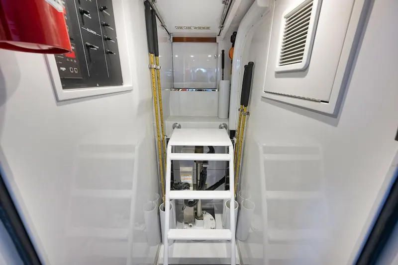 Slide: The Image of Interior of 2016 Merritt 86' Enclosed Flybridge, featuring ladder and control panels. - 31
