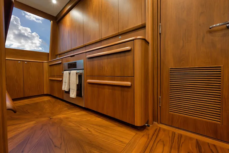 Slide: The Image of Luxurious wood interior of 2016 Merritt 86' Enclosed Flybridge yacht kitchen. - 43