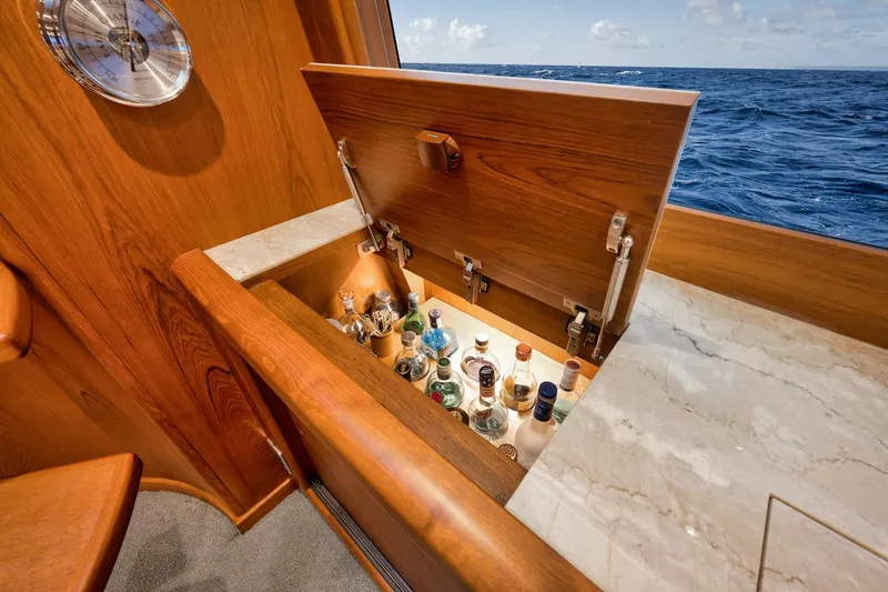 Slide: The Image of Luxurious yacht bar with open liquor cabinet on Merritt 86' Enclosed Flybridge, 2016 model. - 44